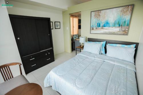 a bedroom with a bed and a black dresser at A2JSuites Bedroom Taal View Luxury Smart Home Suite Near Skyranch in Tagaytay