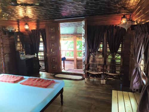a room with a bed and a door to a porch at Sea Hut Homestay in Cochin