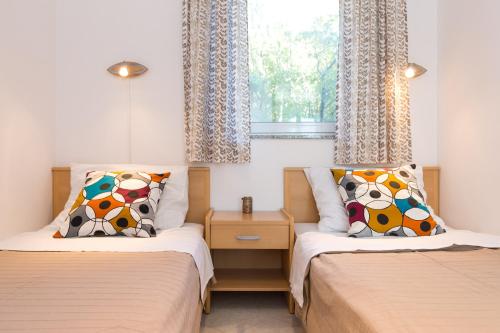 Posteľ alebo postele v izbe v ubytovaní Apartments Krajina
