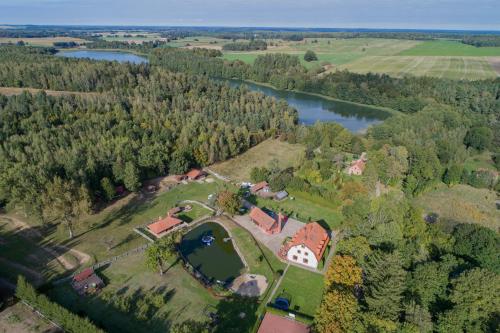 an aerial view of a house and a lake at Osada Ulnowo - Holliday & Party House in Grunwald