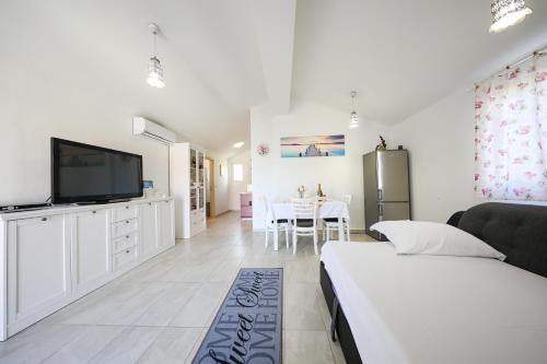 a bedroom with a bed and a tv and a table at Holiday Home Ana in Poljana