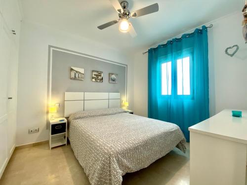 a bedroom with a bed and a blue curtain at Apartamento beach house in Las Palmas de Gran Canaria