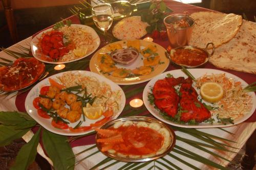 a table full of plates of food on a table at Ravine Lodge in Livingstone