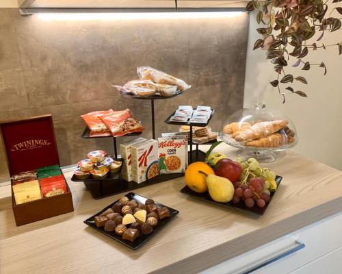 a buffet with different types of food on a counter at B&B Nearby Malpensa in Samarate