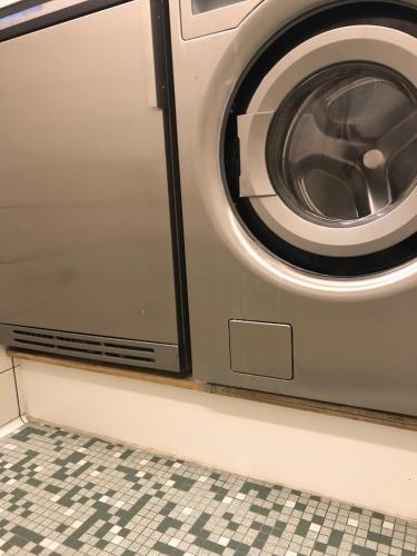a washing machine is sitting in a room at Harbour Living by Jutlandia - Hostel Style in Frederikshavn