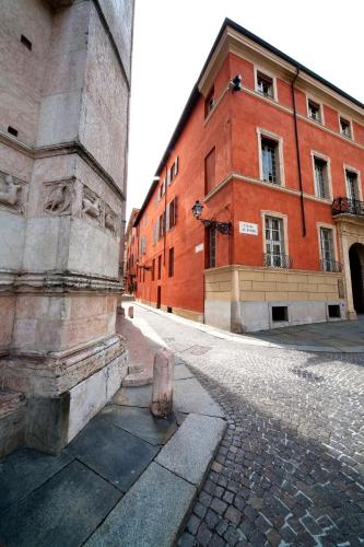 an empty street next to a red brick building at Palazzo Dalla Rosa Prati in Parma