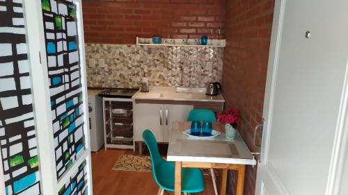 a small kitchen with a table and chairs at Casa 24 Puerto Iguazu in Puerto Iguazú