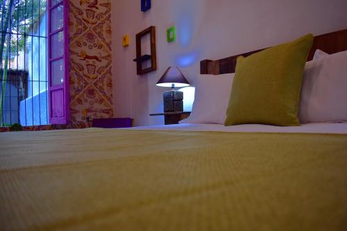 a bedroom with a large bed and a window at Tlaquepaque Pueblito in Guadalajara