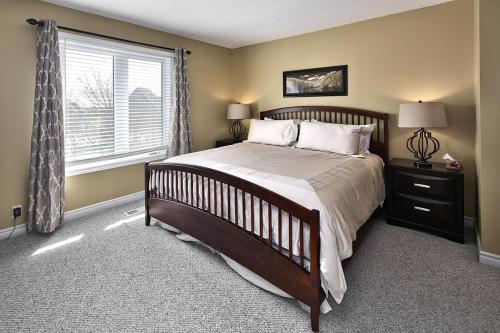a bedroom with a large bed and a window at Large luxurious upper floor condo in Sierra Lane in Blue Mountains