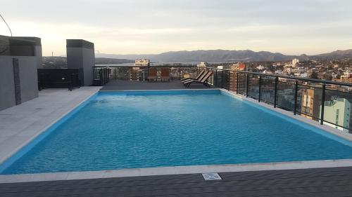 a swimming pool on the roof of a building at Serendipia Carlos Paz in Villa Carlos Paz