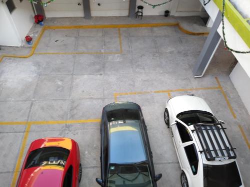 an overhead view of two cars parked in a garage at Hotel Juarez in Cuernavaca
