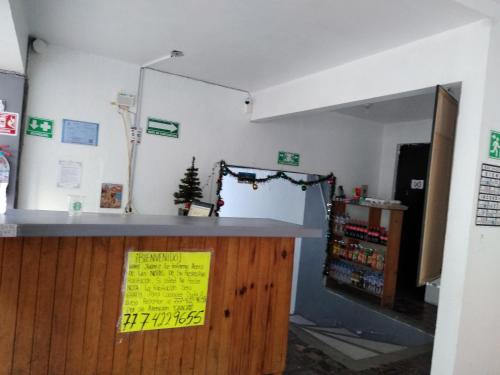 a shop with a counter with a yellow sign on it at Hotel Juarez in Cuernavaca
