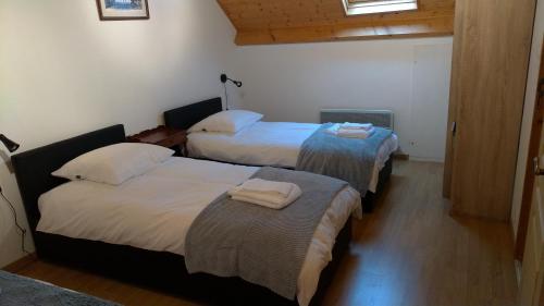 a hotel room with two beds with towels on them at Les Guernazelles in Bracieux