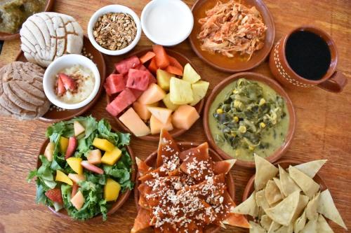 a table topped with bowls of different types of food at Tlaquepaque Pueblito in Guadalajara