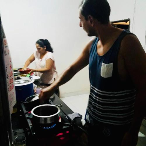a man and a woman preparing food in a kitchen at Bangalawa Resort in Habarana