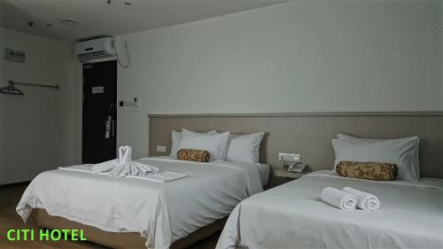 Postel nebo postele na pokoji v ubytování Citi Hotel