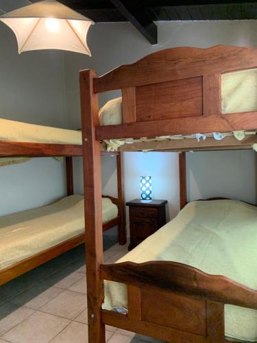 1 dormitorio con 4 literas y una lámpara en Chalet con piscina en Chivilcoy