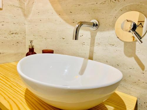 a sink with a faucet in a bathroom at The Arch - Charming Apartments in the Historic Center in Braga