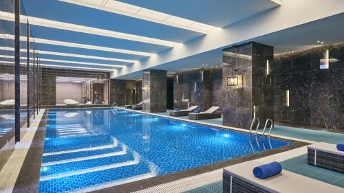a pool in a hotel with blue lighting at Crowne Plaza Wuhan Development Zone, an IHG Hotel in Wuhan