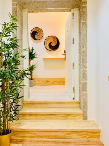 a hallway with wooden floors and plates on the wall at The Arch - Charming Apartments in the Historic Center in Braga
