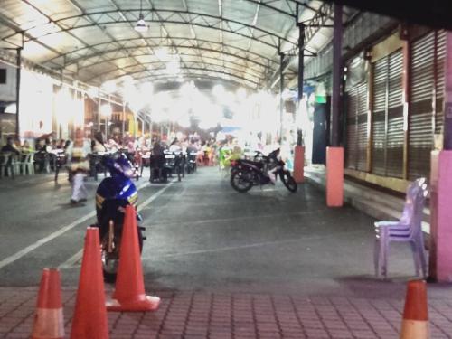 a person riding a bike in a building with orange cones at Sp Central Hotel in Sungai Petani