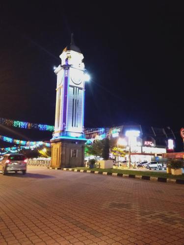 a clock tower in a city at night at Sp Central Hotel in Sungai Petani