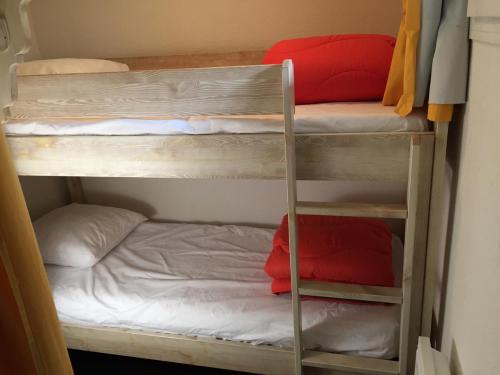 two bunk beds in a room with a bed at Loc luz st sauveur 4 in Luz-Saint-Sauveur