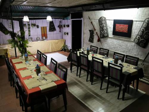a dining room with tables and chairs in a restaurant at Razhu Pru in Kohīma