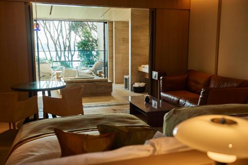 a living room with a couch and a table at THE HIRAMATSU HOTELS & RESORTS KASHIKOJIMA in Shima