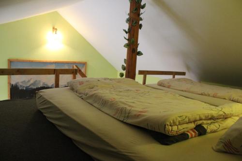 a bedroom with two beds in a attic at Marko Apartmány in Oščadnica