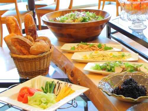 a table with plates of food on top at Hiroshima City Bunka Koryu Kaikan in Hiroshima