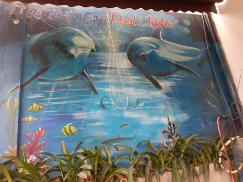 a mural of two dolphins in the ocean at Thien Thanh Hotel in Phong Nha