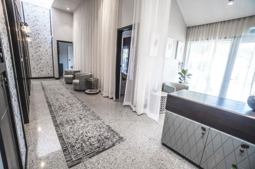 a lobby with a waiting room with chairs and a hallway at Gibbston Valley Lodge and Spa in Queenstown