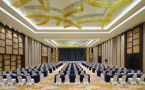 a conference room with chairs and a stage in the middle at Crowne Plaza Nanning City Center by IHG in Nanning