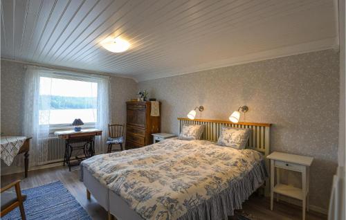 a bedroom with a bed and a window at Nice Home In Årjäng With Wifi in Årjäng