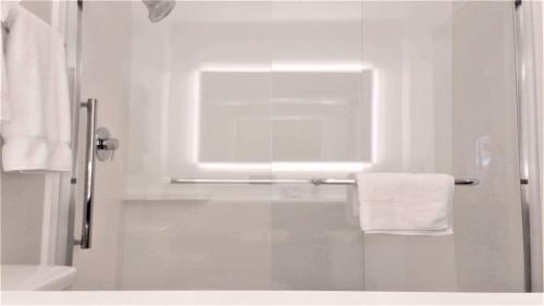 a white bathroom with a shower with a towel at Holiday Inn Express & Suites Hood River by IHG in Hood River