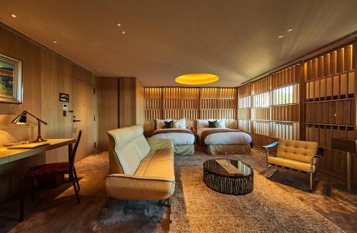 a hotel room with two beds and a desk at THE HIRAMATSU HOTELS & RESORTS KASHIKOJIMA in Shima