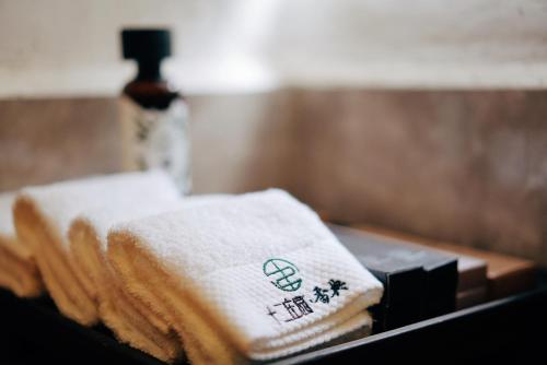 a pile of towels sitting on top of a table at The Twelve Manor•Terraces Lodge in Yuanyang