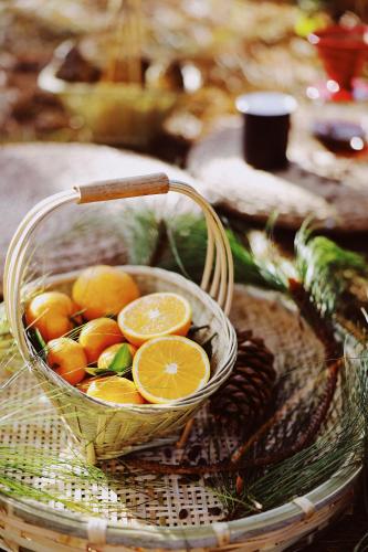a basket filled with oranges on top of a table at The Twelve Manor•Terraces Lodge in Yuanyang