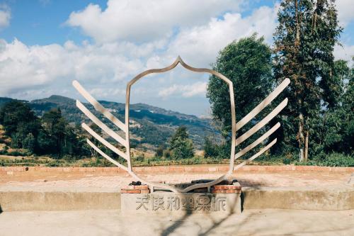 a large metal sculpture of a pair of wings at The Twelve Manor•Terraces Lodge in Yuanyang