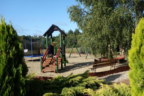 a park with a playground with a swing set at Bednarzówka in Nowy Tomyśl