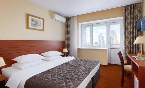 a hotel room with a bed and a window at Bega Hotel Moscow in Moscow