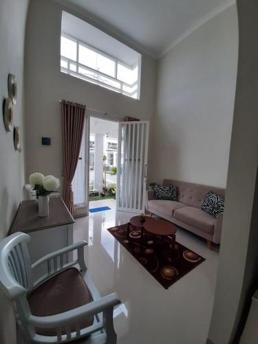 a living room with a couch and a table at Villa Blossom Kayana Regency E7 in Batu