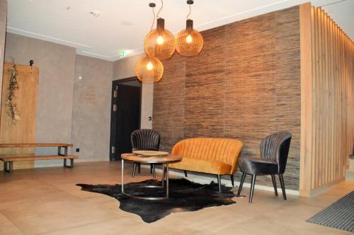 a room with a table and chairs and a brick wall at Herz3 Hotel Bar Restaurant Trattoria in Hollersbach im Pinzgau