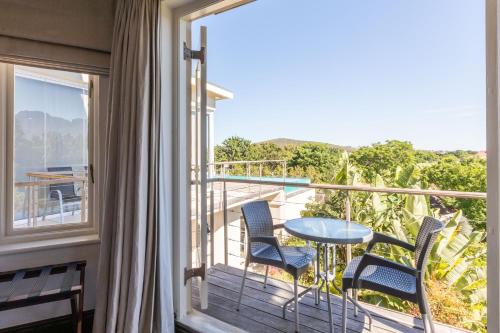 a balcony with a table and chairs and a view at 4 Piet Retief in Stellenbosch
