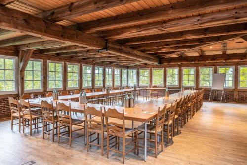 a large room with a long table and chairs at Landhaus Haverbeckhof in Niederhaverbeck