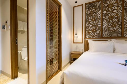 En eller flere senge i et værelse på Daisy Boutique Hotel