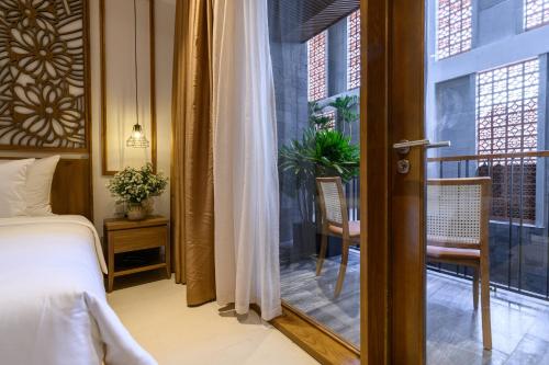 En eller flere senge i et værelse på Daisy Boutique Hotel