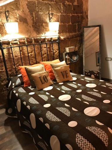 a bedroom with a large bed with pillows on it at Nuestra Casita de Papel in Cehegín