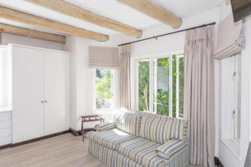 a living room with a couch and a window at 4 Piet Retief in Stellenbosch